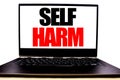 Handwritten text showing Self Harm. Business concept writing for Selfharm Mental Aggression Written on monitor front screen, white