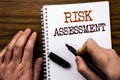 Handwritten text showing word Risk Assessment. Business concept for Safety Danger Analyze Written on tablet laptop, wooden backgro Royalty Free Stock Photo