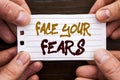 Handwritten text sign showing Face Your Fears. Business concept for Challenge Fear Fourage Confidence Brave Bravery written on Sti