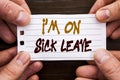 Handwritten text sign showing I m am On Sick Leave. Business concept for Vacation Holiday Absent Out Of Office Sickness Fever writ