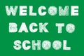 Handwritten white bold chalk lettering welcome back to school text on green background Royalty Free Stock Photo