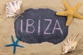 Handwritten word IBIZA written in chalk, among seashells and starfishes Royalty Free Stock Photo