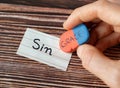 Handwritten word sin with a hand holding a rubber eraser with grace text on wooden background
