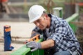 handy man using level on fence Royalty Free Stock Photo