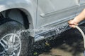 Handy man washing car by himself Royalty Free Stock Photo