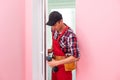 handyman adjusting white pvc plastic window indoors. worker using screwdriver to repair upvc window. homework