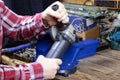 A handyman with angular grinding machine. Men`s hands holding an angular grinding machine. A locksmith vise Royalty Free Stock Photo