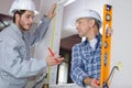 Handyman with apprentice working in new home