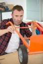 handyman assembling wheeled trolley Royalty Free Stock Photo