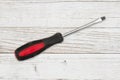 Handyman background with red and black screwdriver on distressed whitewash background