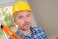 Handyman carrying spirit level Royalty Free Stock Photo