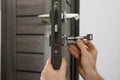 Handyman changing core of door lock, closeup Royalty Free Stock Photo