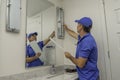 Handyman changing out a lightbulb in bathroom