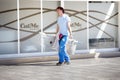 Handyman cleaning is walking down street with a ladder and bucket and cleaning tools