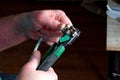 A handyman crimps electrical wires with a crimper. Wiring repair and replacement concept Royalty Free Stock Photo