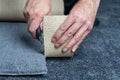 Handyman cutting a new carpet with a carpet cutter. Royalty Free Stock Photo