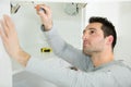 Handyman fixing door on cupboard