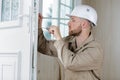 handyman fixing door with screwdriver Royalty Free Stock Photo