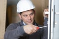 handyman fixing door with screwdriver Royalty Free Stock Photo