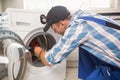 Handyman fixing a washing machine