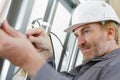 Handyman fixing window with screwdriver Royalty Free Stock Photo