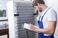 Handyman during fridge repair Royalty Free Stock Photo