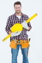 Handyman holding hard hat and spirit level Royalty Free Stock Photo