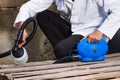 Handyman holding in his hand the painting spray, construction worker painting with spray gun in outdoors a wooden Royalty Free Stock Photo