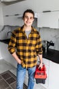 Handyman holding tools standing in kitchen. Professional plumbing services Royalty Free Stock Photo