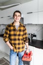 Handyman holding tools standing in kitchen. Professional plumbing services Royalty Free Stock Photo