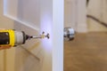 Handyman install new door handle in the room Royalty Free Stock Photo