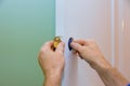 handyman installing the door lock in worker& x27;s hands installing new door locker Royalty Free Stock Photo