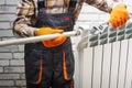 Handyman installing heating radiator in the room Royalty Free Stock Photo