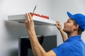 Handyman installing shelf on the wall