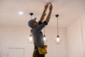 Handyman installing a smoke detector on the ceiling Royalty Free Stock Photo