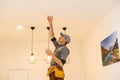 Handyman installing a smoke detector on the ceiling Royalty Free Stock Photo