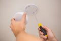 Handyman installing smoke detector Royalty Free Stock Photo