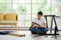 Handyman installing wooden bench in new house. House renovation service. Morning work atmosphere in the living room