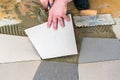 Handyman laying ceramic floor tiles