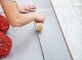 Handyman`s hands laying down laminate flooring boards Royalty Free Stock Photo