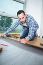 handyman laying down laminate wood flooring boards Royalty Free Stock Photo