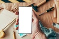 Handyman maintenance worker holding smartphone with blank mock up screen