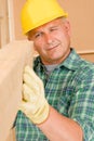 Handyman mature carpenter measure wooden beam Royalty Free Stock Photo