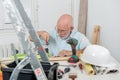 Handyman mature man with blue shirt, DIY at home