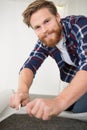 handyman putting lino on floor Royalty Free Stock Photo