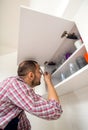 Handyman repair door on the cabinet in the kitchen Royalty Free Stock Photo