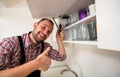 Handyman repair door on the cabinet in the kitchen Royalty Free Stock Photo