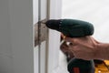 A handyman repair the door lock in the room. The concept repair yourself. Selective focus Royalty Free Stock Photo