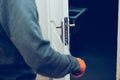 Close up of handyman repair the door lock in the room, fixing lock with screwdriver in the home or office Royalty Free Stock Photo