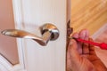 Handyman repair the door lock in the room, Man fixing lock with screwdriver, Close-up of repairing door, professional locksmith Royalty Free Stock Photo